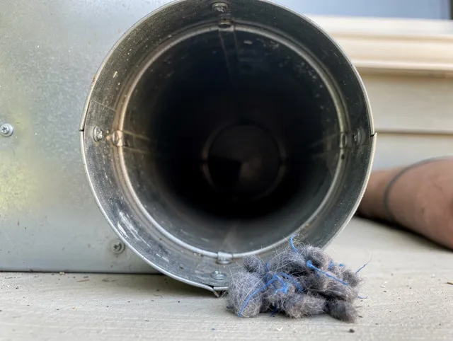 Fort Mill Dryer Vent Cleaning technician using specialized equipment to clear severe dryer vent blockage in Fort Mill